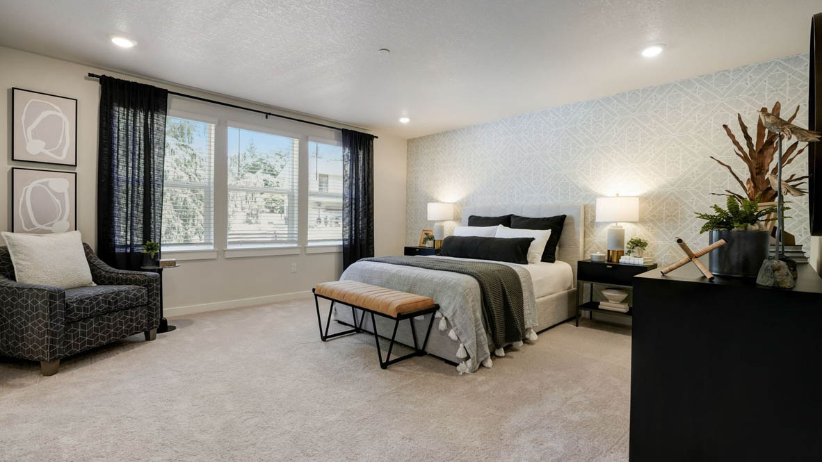 Sorrento Estates Walk in closet with clothing hanging and storage boxes above