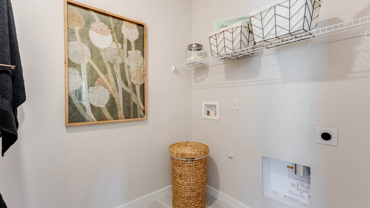 Sorrento Estates Laundry room with wire shelving and a hamper