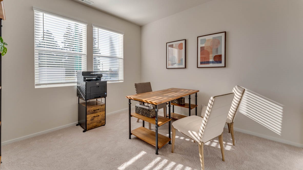 Sorrento Estates office with a desk, chair, windows, paintings, carpet