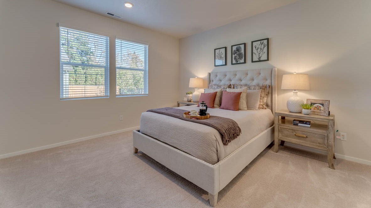 Sorrento Estates Primary bedroom with a bed, carpet, paintings, nightstand with a lamp, dresser with a lamp