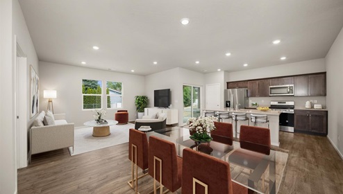 Dining area with a glass table and six burnt orange dining chairs, to the back left you can see the living area and the back right you can see into the kitchen area.
