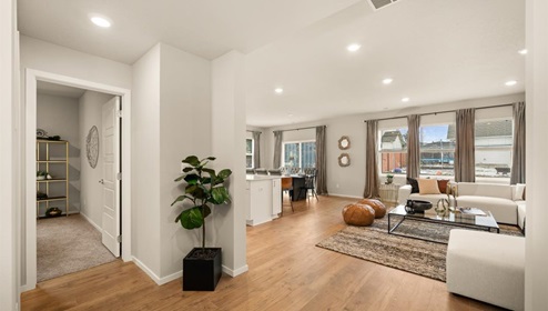 A living area with a large couch and a large patterned area rug.