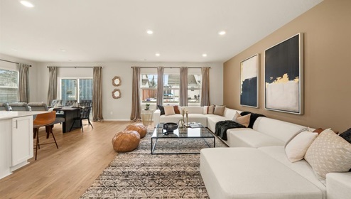 A living area with a large couch and a large patterned area rug.