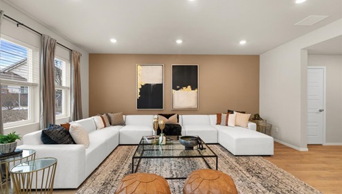 A living area with a large couch and a large patterned area rug.