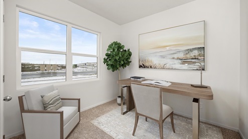 A room with a wooden desk against the right wall with a large painting hung above and a wooden chair in front of the desk. There's an accent chair in the left corner and a tall plant in the corner. There are two windows letting in natural light.