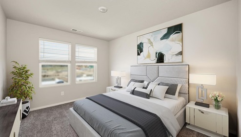 A bedroom with a bed with white and grey sheets, two bedside tables with lamps, an abstract painting hanging above the bed, and two large windows letting in natural light.