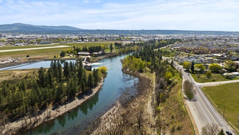 An aerial view of the nearby forest and Spokane River.