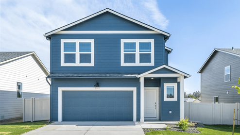 Photo of a two story home with blue siding and white accents.