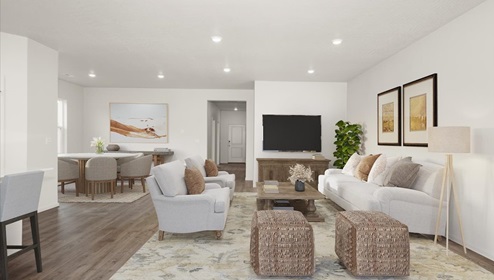 A living area with a light rug, white couch and accent chairs, a wood coffee table, and a view into the dining area.
