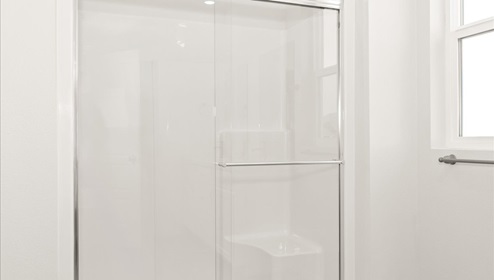 A shower with a glass door.
