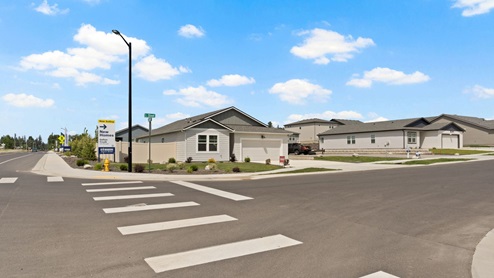 A crosswalk with a Dalton Creek community sign.
