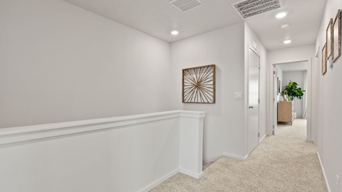 A hallway on the second floor leading to bedrooms.