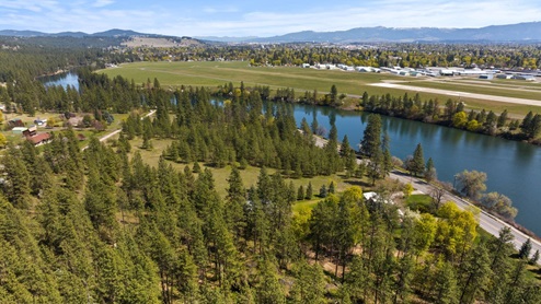 An aerial view of the nearby forest and Spokane River.