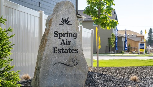 Photo of a stone community sign that reads "Spring Air Estates"