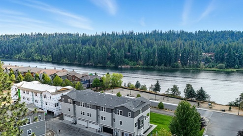 A drone shot of the Spokane River across the street from Grand Mill Townhomes