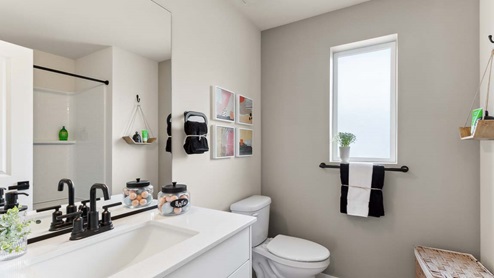 Upstairs hall bath with quartz countertop vanity and bright window
