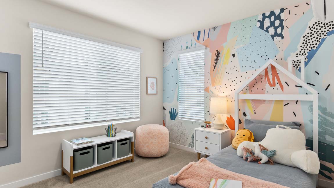 This secondary bedroom in the Addison model home at Cathcart Crossing provides two bright windows