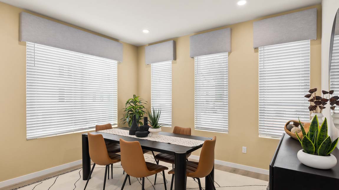 Full view of Addison model home dining room with four bright windows