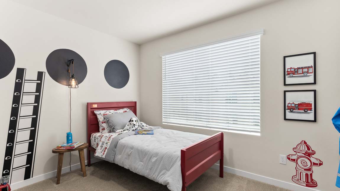 This secondary bedroom in Addison home design provides one large window