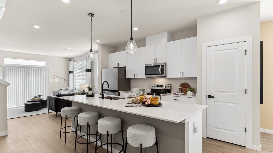 Addison floor plan furnished model home kitchen with large island and white cabinetry