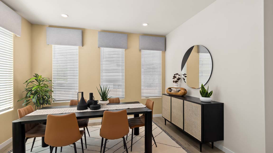 Full view of Addison model home dining room with four bright windows