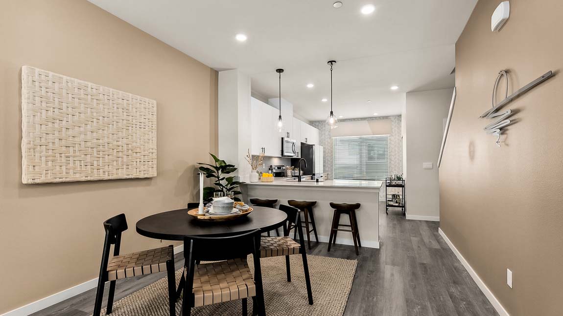 Closer view of large kitchen window and stainless-steel refrigerator inside the Bennett model home at Cathcart Crossing