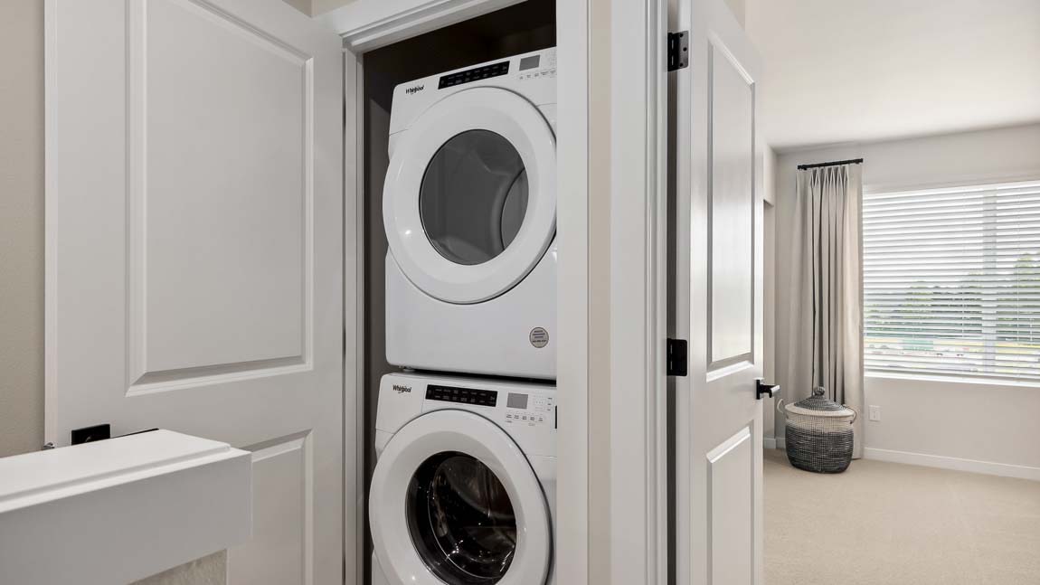 Stacking washer and dryer inside laundry closet on upper floor of Bennett floor plan