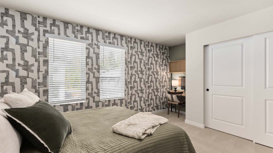 Upper floor bedroom with desk area beside the sliding-door storage closet