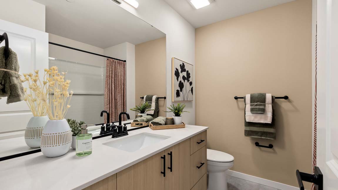 Bennett model home hallway bathroom with quartz countertop vanity and built-in tub-shower combo