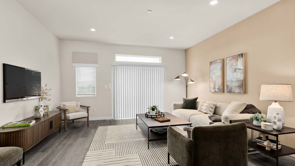 Wide angle view of entire living room of Bennett model home featuring slider door access to balcony