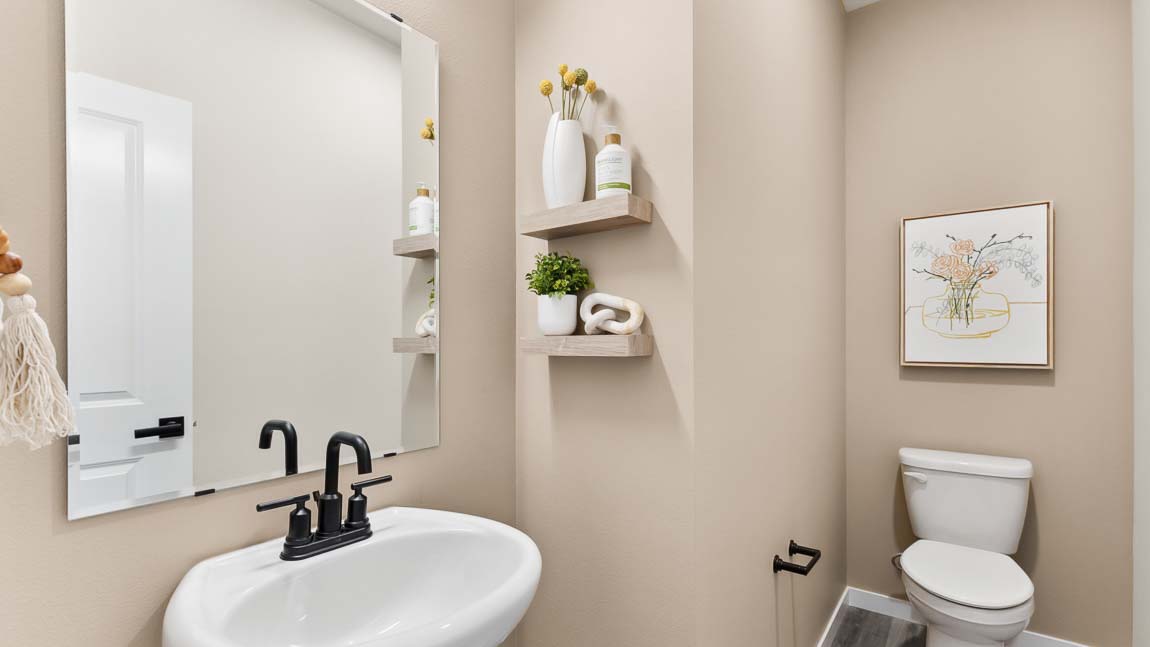 Bennett model home powder room with pedestal sink and mirror