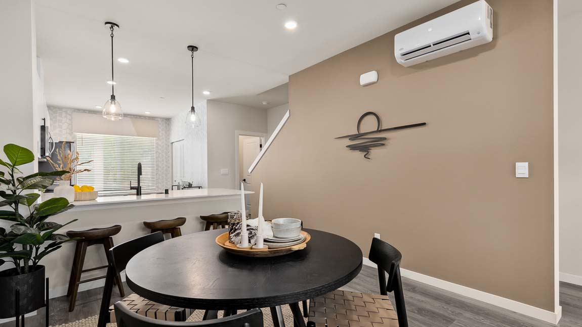 Bennett floor plan model home dining room with kitchen in background