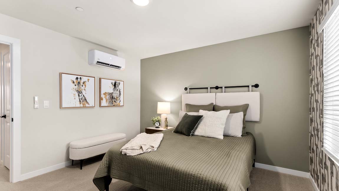 Alternate view of Bennett model bedroom that includes bright windows and space for seating or a desk