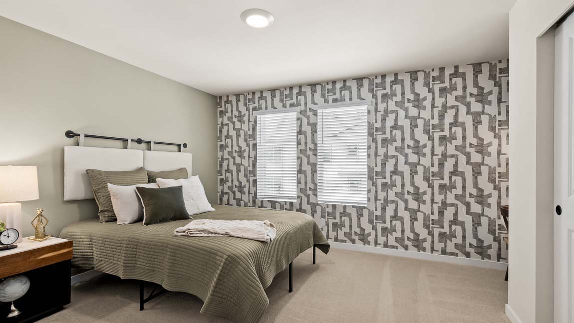 Upper floor bedroom with two bright windows and storage closet