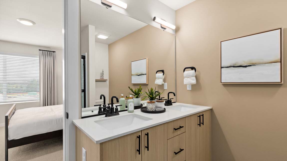 Closer view of the Bennett private upstairs bathroom double-sink vanity with quartz countertops and modern light fixtures