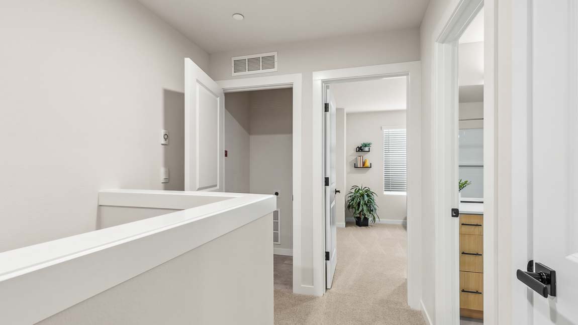 Capri floor plan upper floor hallway landing view of laundry closet for stackable washer and dryer
