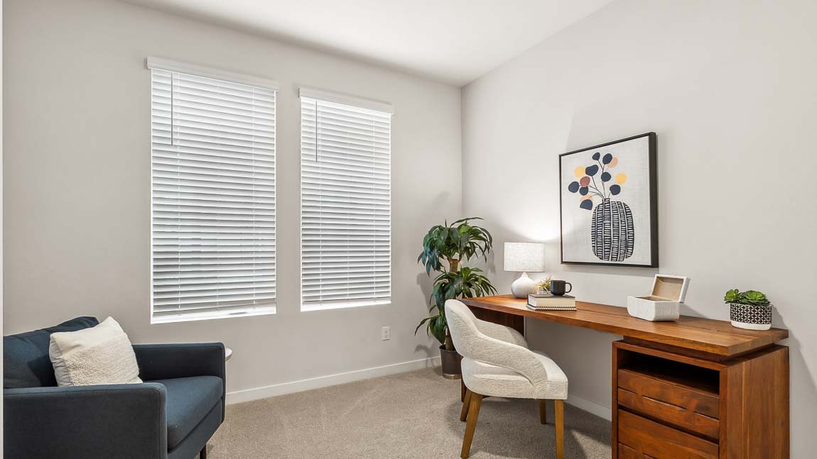 Main floor secondary bedroom is being used in the Capri model home as a home office
