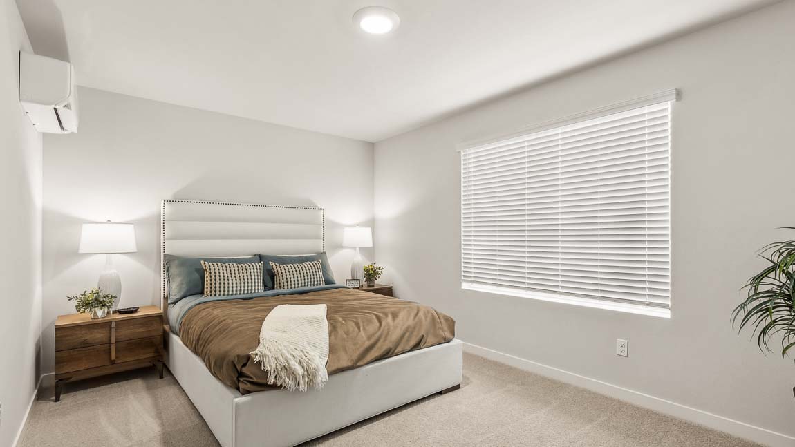 Closer view of bedroom in the private bedroom suite located at rear of the home