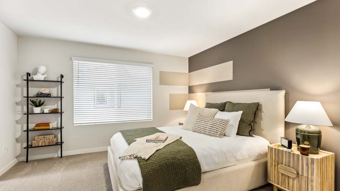 Spacious primary bedroom with recessed lighting and large window Nolan Square – Web 25: Primary bathroom with dual sinks and quartz countertops