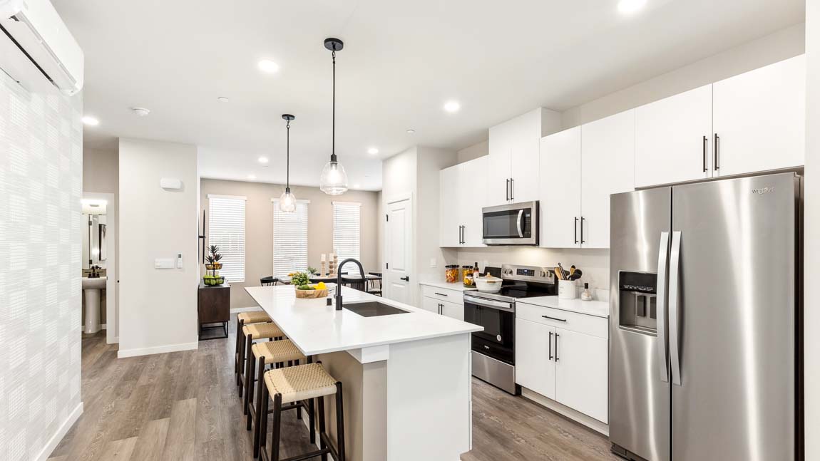 Interior view of kitchen and dining room with access to powder room