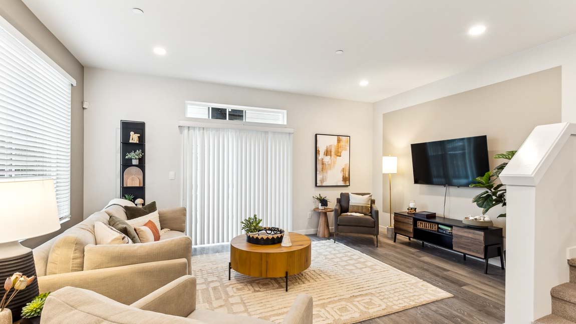 Living room with large windows and outdoor patio access sliding door