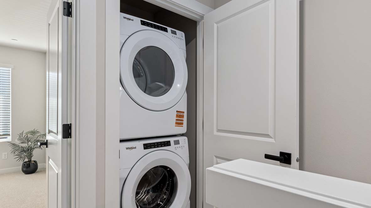 Stacking washer and dryer inside laundry closet on upper floor of Bennett floor plan