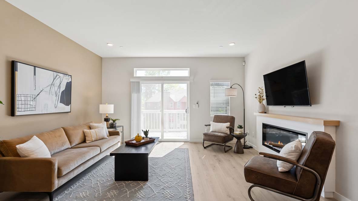 Wide angle view of entire living room of Bennett model home featuring slider door access to balcony