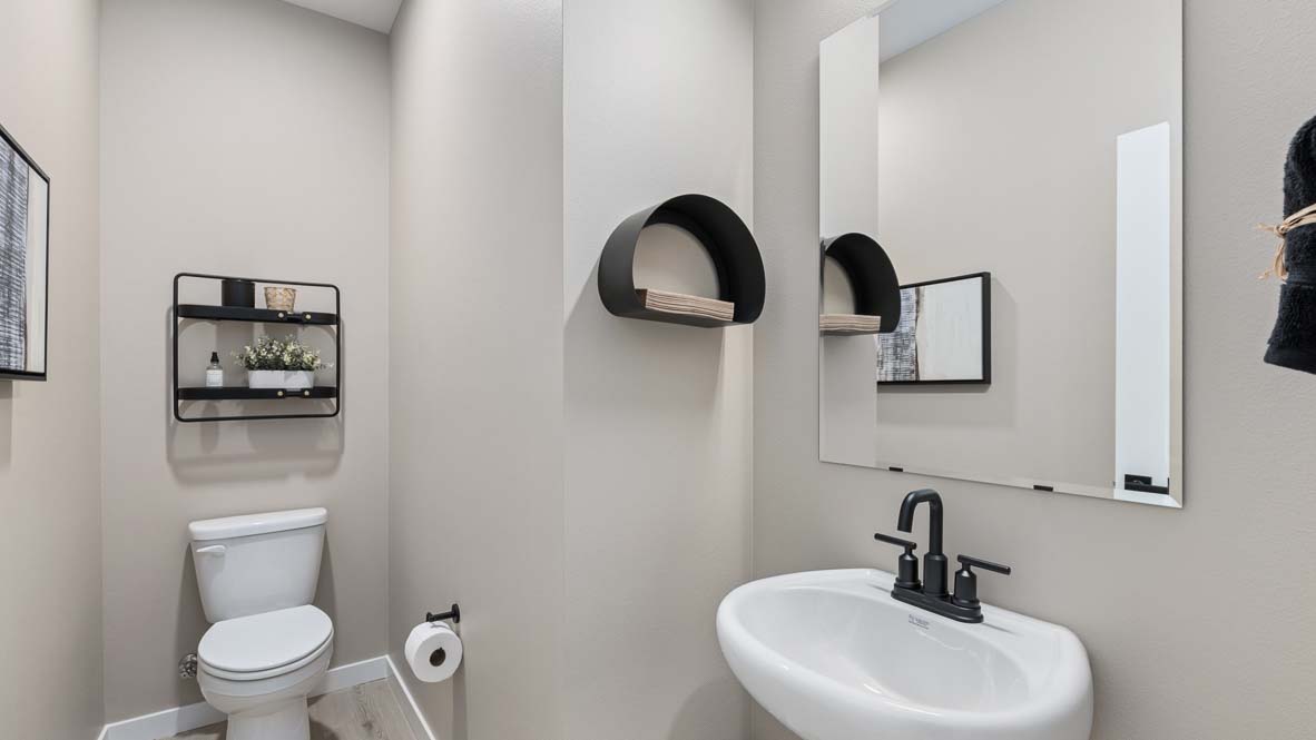 Bennett model home powder room with pedestal sink and mirror