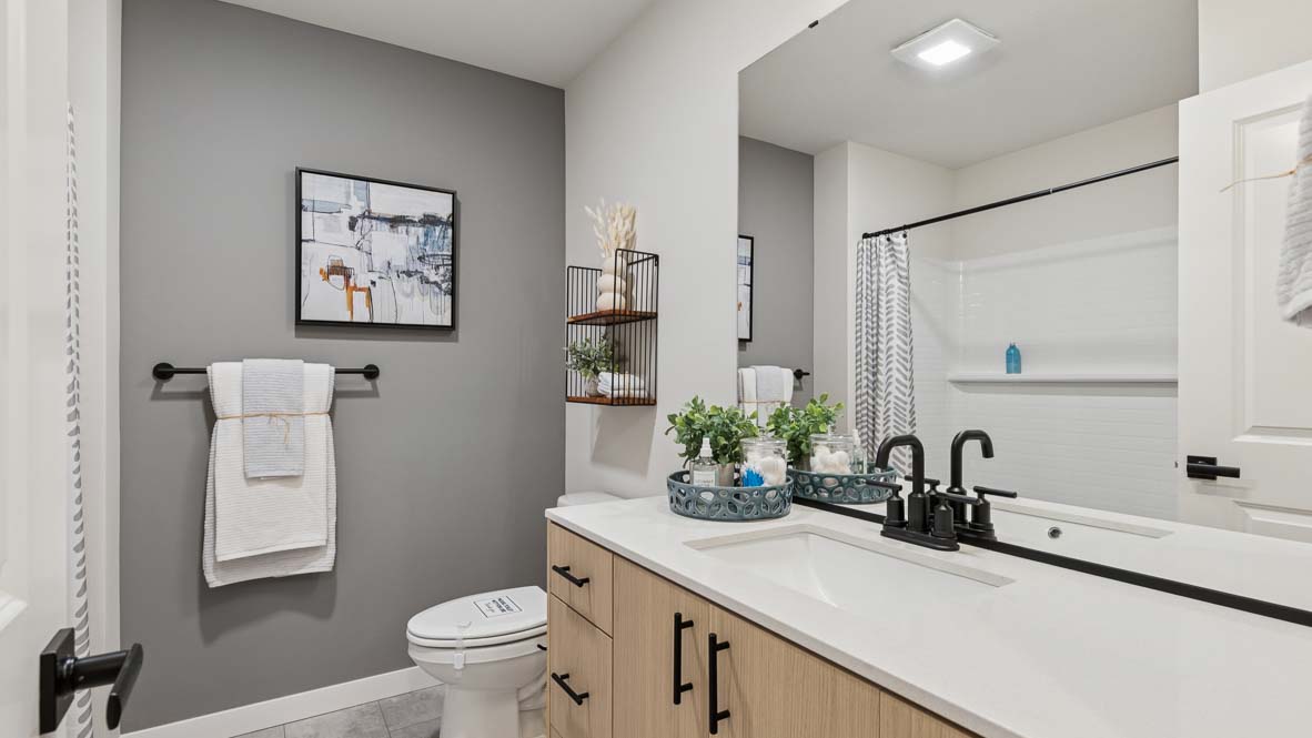 Bennett model home hallway bathroom with quartz countertop vanity and built-in tub-shower combo