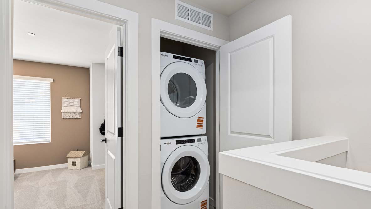 Capri floor plan upper floor hallway landing view of laundry closet for stackable washer and dryer