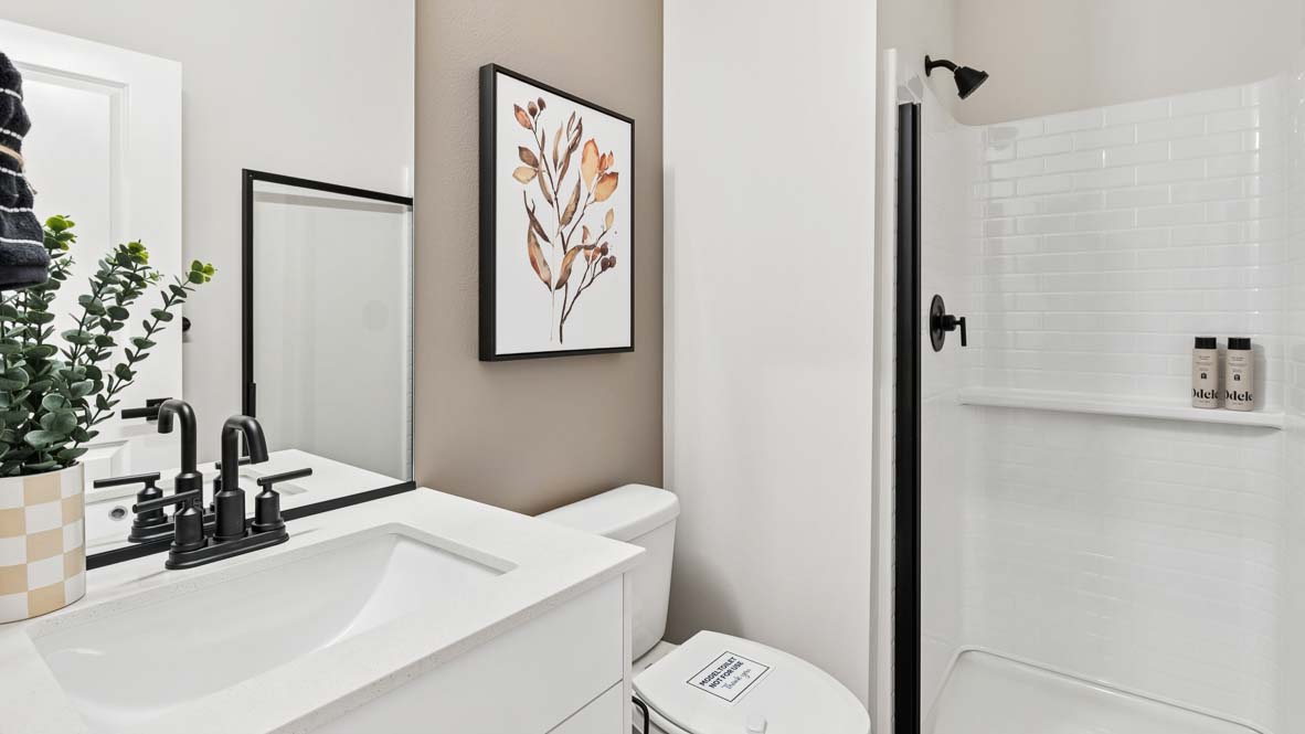 Capri model main floor three-quarter bathroom featuring quartz countertop vanity with undermount sink and step-in shower