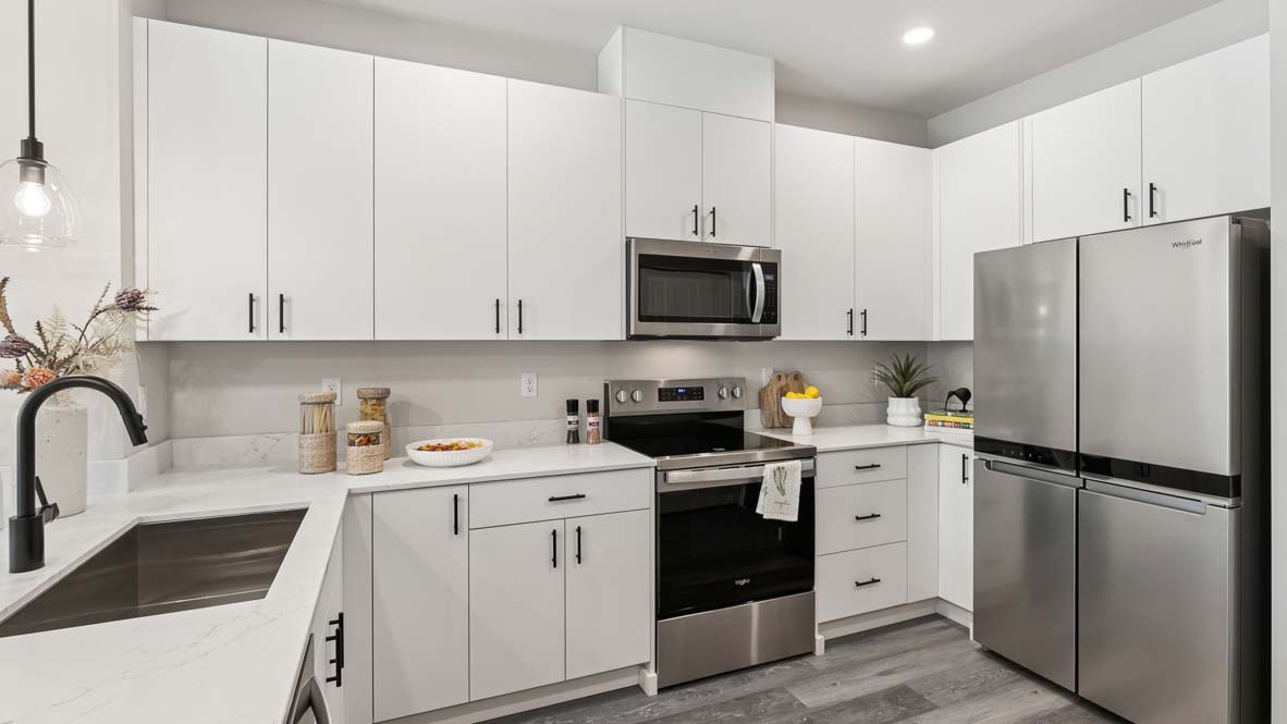 White cabinetry with ample storage space in kitchen