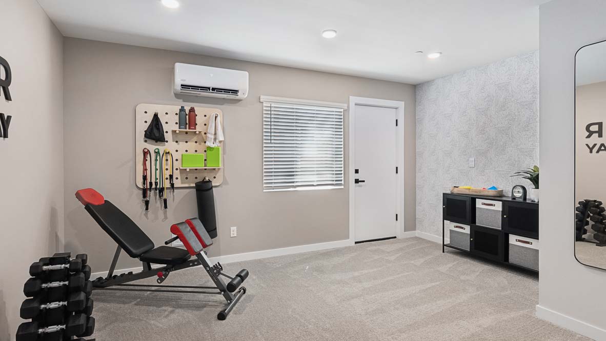 Versatile flex-space bedroom is showcased as a home gym