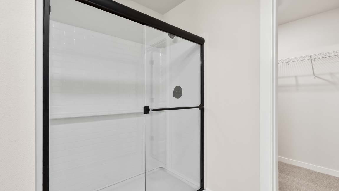 Huge walk-in shower with sliding door in primary bath